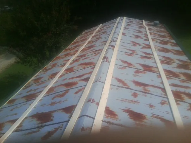 Rusted metal roof panels with new wood purlins before replacement — Storm Damage Roof Repair in Bliss by Roofing Brothers